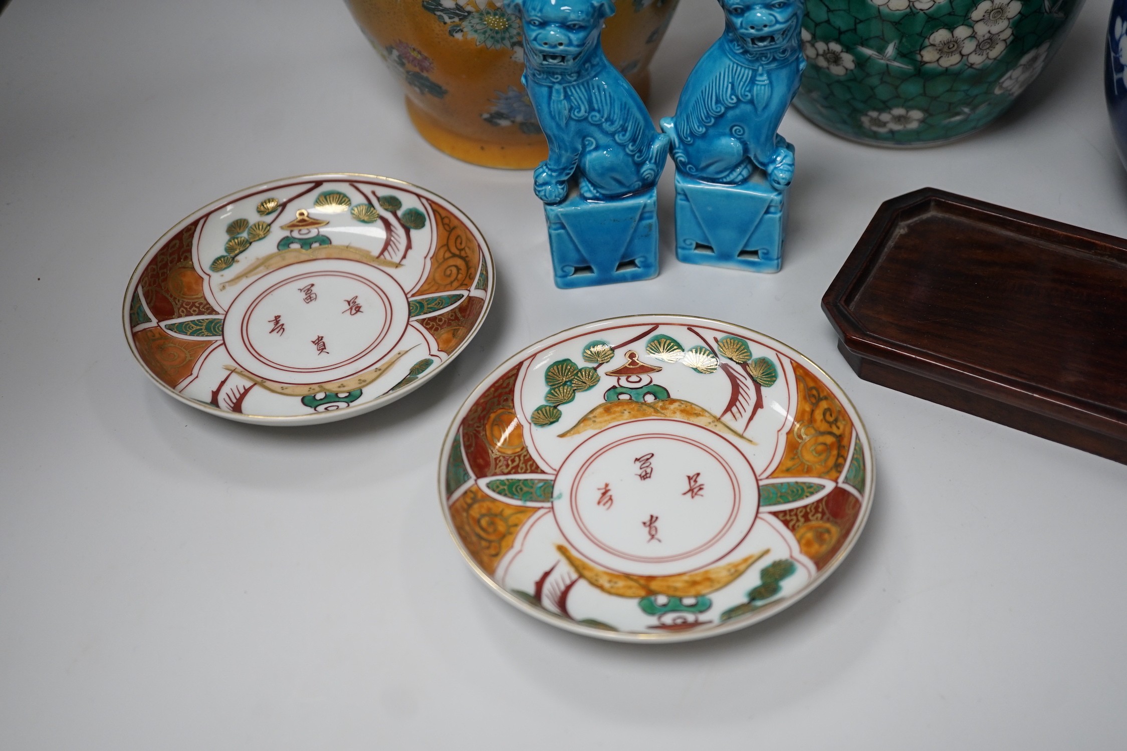 Two Chinese ginger jars, a pair of turquoise lion dogs, a Japanese vase and two similar saucers. Tallest 30cm